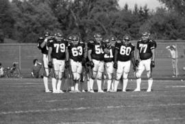 St. Cloud State football players stand together on the field during a game against the University of South Dakota