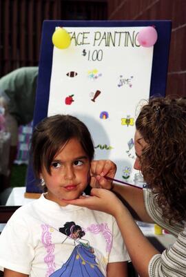 A girl gets her face painted, Lemonade Concert and Art Fair, St. Cloud State University