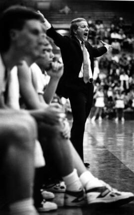 Men's basketball coach Butch Raymond stands on the sideline, St. Cloud State University