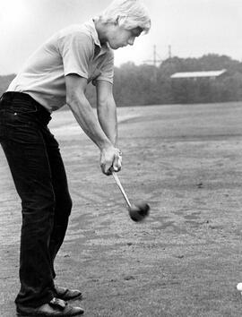 Jim Moti hits a golf ball, St. Cloud State University