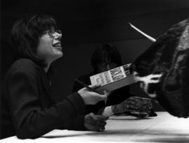 Susan Faludi signs books after speaking at a Women on Wednesday speaker series, St. Cloud State University