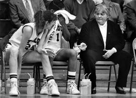 Women's basketball coach Gladys Ziemer sits on the sidelines, St. Cloud State University