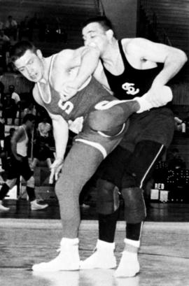 Mike Rybak wrestles an opponent, St. Cloud State University