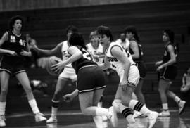 Dawn Anderson tries to get a basketball from another player in a game against the University of South Dakota, St. Cloud State University