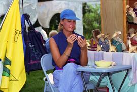 A woman paints an egg, Lemonade Fair, St. Cloud State University