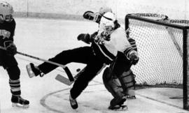 St. Cloud State University hockey player Rian Reed stands in front of a hockey net during a game against Mankato State University