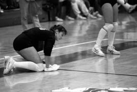 Kathy Davis wipes the floor during a volleyball match against Macalester College, St. Cloud State University