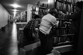 People pack books into boxes to prepare for the move from Kiehle (1952) to Centennial Hall (1971), St. Cloud State University