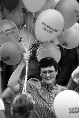 A woman holds balloons, Lemonade Concert and Art Fair, St. Cloud State University