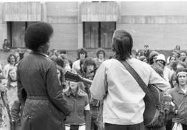 A man plays guitar, Day of Peace protest, St. Cloud State University