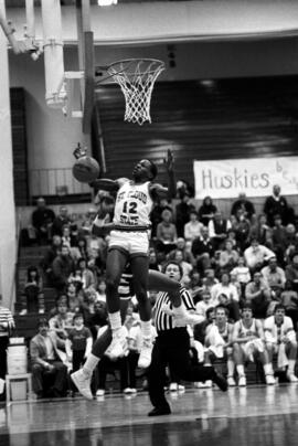 Cleveland Barnes jumps near the basketball hoop in a game against the University of Minnesota-Duluth, St. Cloud State University