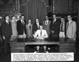 Minnesota Governor Wendell Anderson signs legislation renaming the state college system into a state university system