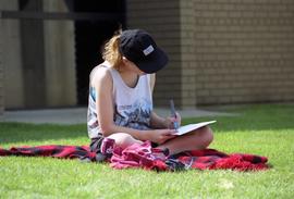 A woman studies during the Lemonade Concert and Art Fair, St. Cloud State University