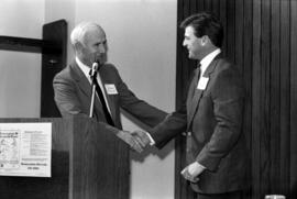 President Brendan McDonald shakes hands with Jeff Passolt during alumni awards banquet, St. Cloud State University