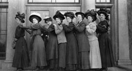 Women stand in front of Lawrence Hall (1905) entrance, St. Cloud State University