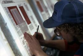 Man works on putting the Chronicle newspaper together, St. Cloud State University