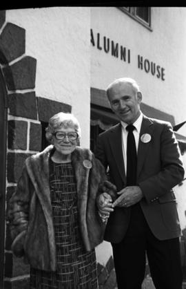 Lydia Olander and St. Cloud State University president Brendan McDonald in front of the Alumni House