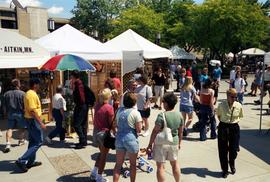 People gather on sidewalks to visit vendors' booths, Lemonade Concert and Art Fair, St. Cloud State University