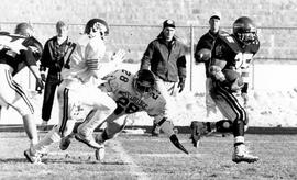 Football player Harry Jackson runs with the ball, St. Cloud State University