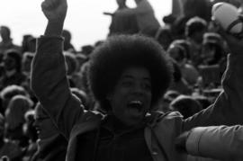 Fan cheers at a homecoming football game, St. Cloud State University