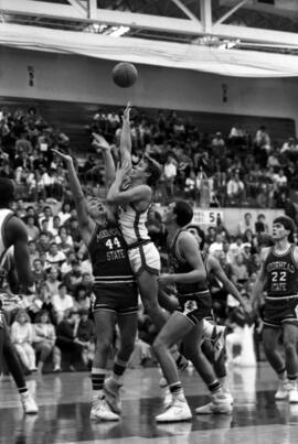 Basketball player Phil Mann shoots during a game against Moorhead State University, St. Cloud State University