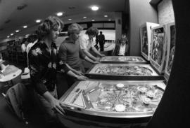 Men play pinball at the Atwood Memorial Center (1966) rec center, St. Cloud State University