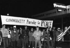 Protesters march and carry a sign that reads "Community Parade for Peace," St. Cloud State University