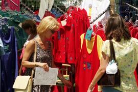 Two women examine clothing, Lemonade Concert and Art Fair, St. Cloud State University