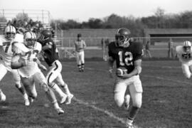 St. Cloud State football player Keith Nord runs with the football in a game against Moorhead State University