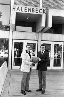 Sam Skarich and Noel Olson stand outside of Halenbeck Hall (1965), St. Cloud State University