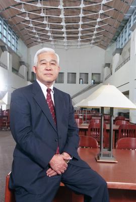 President Roy Saigo sits in the Miller Center (2000) reading court, St. Cloud State University