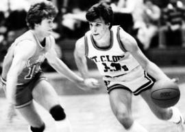 St. Cloud State men's basketball player Gary Madison plays against St. John's University