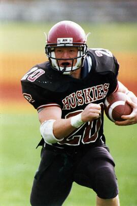 Randy Martin runs with a football during a game, St. Cloud State University