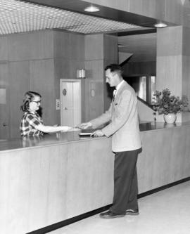 President George Budd checks out the first book from Kiehle (1952), St. Cloud State University