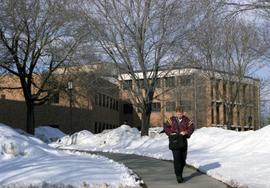 A student walks outside of the School of Business (1968) building, St. Cloud State University