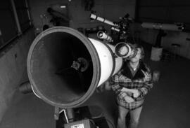 Man looks through telescope, St. Cloud State University