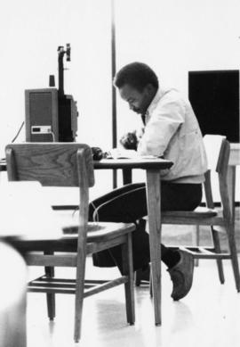 Man studies at a desk, St. Cloud State University