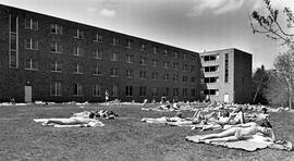 People suntan outside of Mitchell Hall (1958), St. Cloud State University