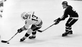 St. Cloud State University men's hockey player David Hoover is followed by the University of Wisconsin-River Falls player Johnny Seidel during a game