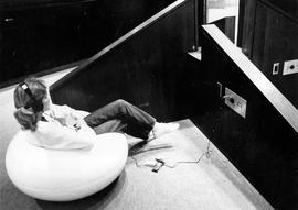 Amy Hebert sits in the Atwood Memorial Center (1966) listening lounge, St. Cloud State University