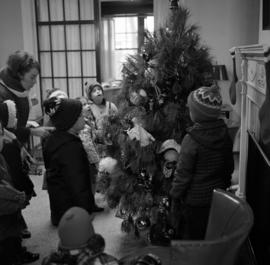 Children inspect the president's Christmas tree in Whitney House (1956), St. Cloud State University