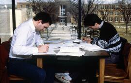 Two men study together at a table in Centennial Hall (1971), St. Cloud State University