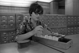 A woman uses a card catalog at Kiehle (1952), St. Cloud State University