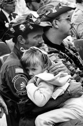 Jim Herbert holds his daugter Eve at the POW/MIA Recognition Day at the St. Cloud Veterans Admini...