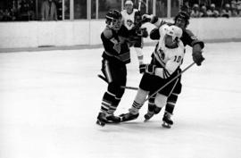 St. Cloud State hockey player Jeff Passolt gets hit during a game against St. Olaf