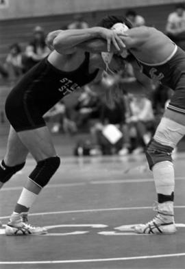 Phil Herbold wrestles another man during a wrestling match, St. Cloud State University