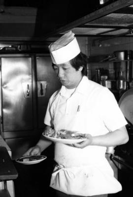 Richard "Butch" Wong serves food at the O.K. Cafe