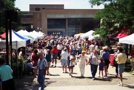 People gather on sidewalks to visit vendors' booths, Lemonade Concert and Art Fair, St. Cloud State University