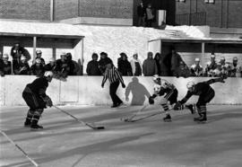 Hockey player Paul Oberstar skates with the puck against Mankato State College, St. Cloud State University