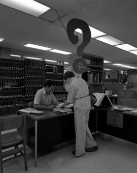 Dick Busse staffs the reference desk, Centennial Hall, St. Cloud State University